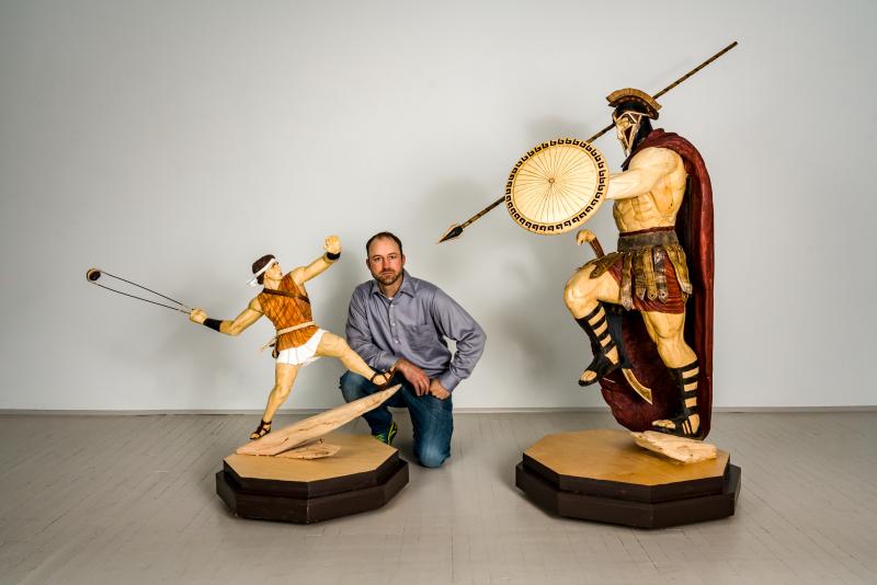 Rockport artist Jon Moro, next to his sculpture of David and nearby his Goliath sculpture. (Photo courtesy Ni Rong)