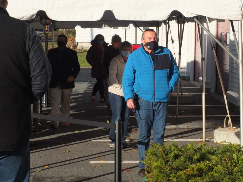 Boothbay Harbor residents brave a strong early morning wind on Election Day as they waited outside the polls before casting ballots. BILL PEARSON/Boothbay Register