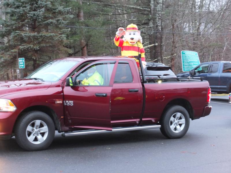 Sparky rides in Boothbay Fire Chief Dick Spofford’s truck in the first Lighted Fire Truck Parade Nov. 28. BILL PEARSON/Boothbay Register