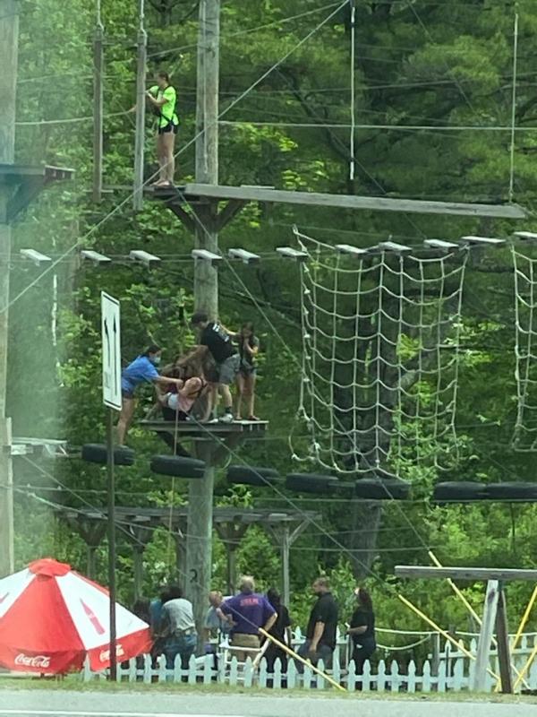 Wiscasset’s Grace Moclair, in a blue T-shirt, and Edgecomb’s Ryan Potter, in a black shirt, help a customer having a medical emergency get off Monkey C Monkey Do’s course and down to Wiscasset responders July 1. Courtesy of Big Al
