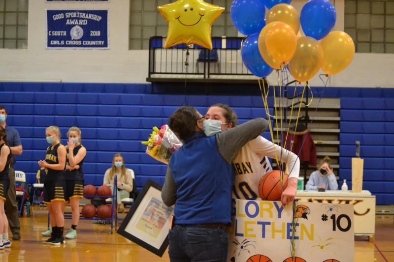 Glory Blethen receives a hug Feb. 15 from mother Lesley Blethen after becoming the sixth Lady Seahawk to score her 1,000th career point. BILL PEARSON/Boothbay Register