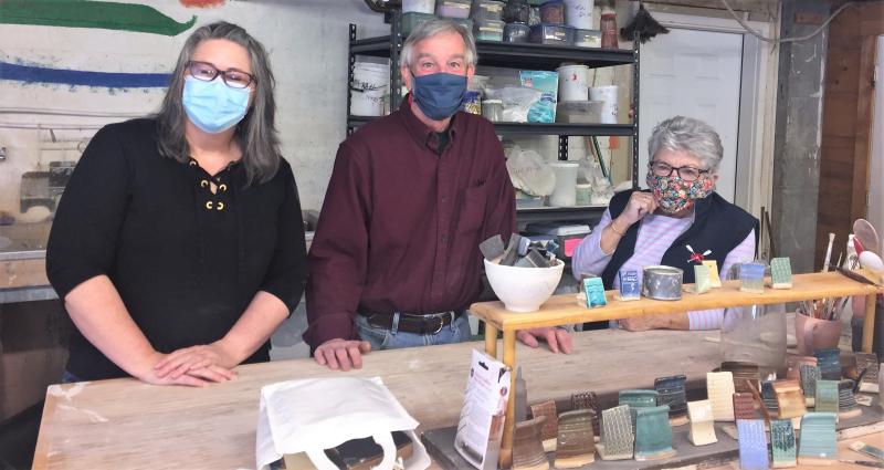 Three of the four members of Midcoast Pottery Co-op at the glazing table. LISA KRISTOFF/Boothbay Register Monica, Clark and Annette