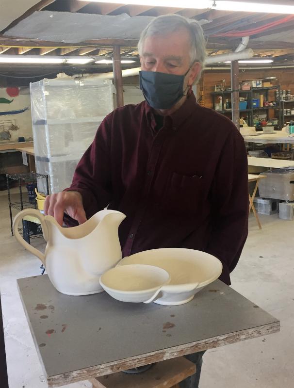 Clark Griffith shows his current project, a pitcher with matching tiered serving dish. LISA KRISTOFF/Boothbay Register BIll Clark