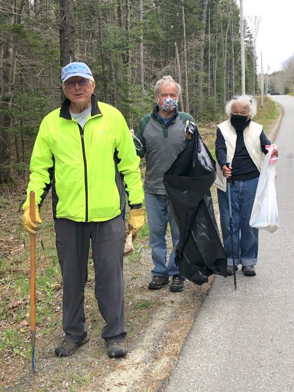 Joe Maziarz, Doug Jones and Isabel Maziarz start to fill bags on Cross Road. JENNY BENNETT/Boothbay Register