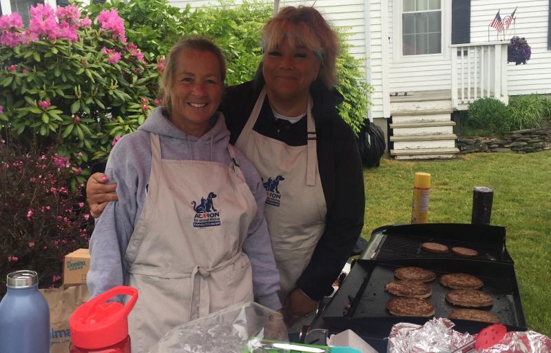 AFA’s Merchandise Coordinator Jackie Helinski, left, and Events Coordinator Betsy Wildes fry up some burgers, veggie burgers and dogs. JOSEPH CHARPENTIER/Boothbay Register
