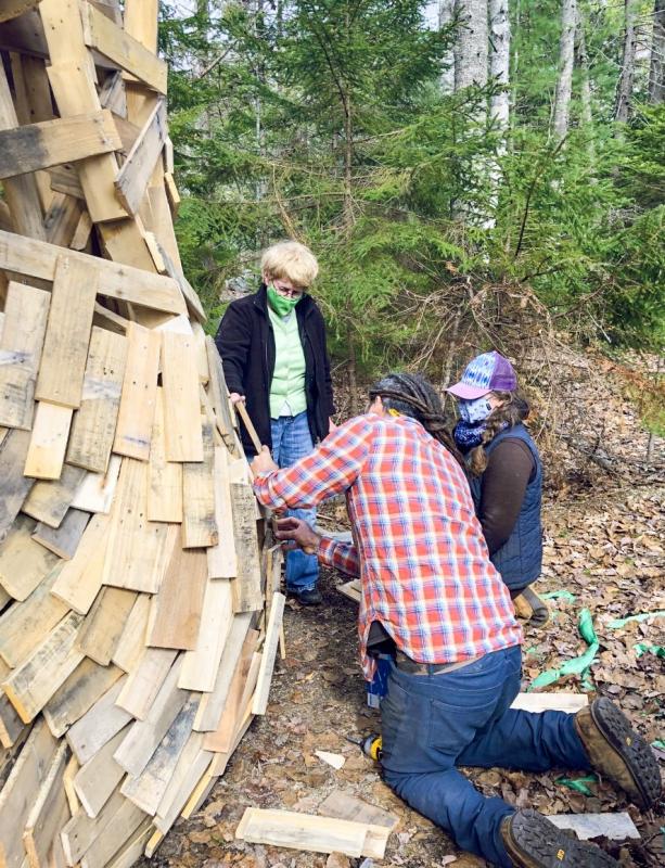 Coastal Maine Botanical Gardens volunteer Louise Cowan assists horticulturist Jenn Dunlap and a member of artist Thomas Dambo’s crew in preparing a new experience planned for this month. Courtesy photo