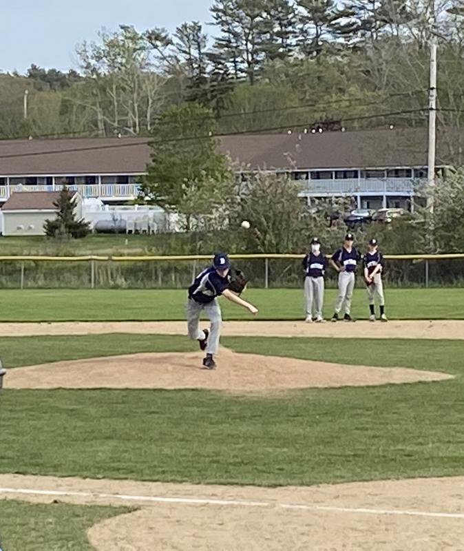 Owen Cotta warms up against Great Salt Bay School watched by Cleyton Splaine, Aidric Canada and Sammy Markowitz. Courtesy of Shanon Cotta