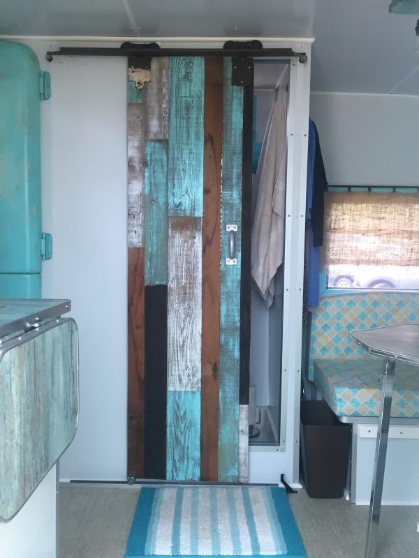 An example of the inventive decorating touches in vintage camper interiors: Part of a barn door, painted in cool colors. LISA KRISTOFF/Boothbay Register