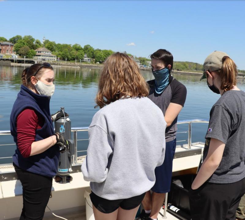 Water collection with Dr. Poulton, holding a YSI. Courtesy of Bruce Wood