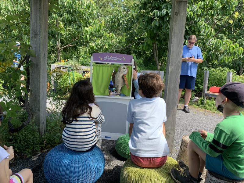 Puppet show under the grape arbor, with the story, "The Blue Jay and the Owl," Carried out by volunteer youth education steward Zoe Curtis and Youth Programs Educator Bridget VerVaet. LILLY CURTIS/Boothbay Register