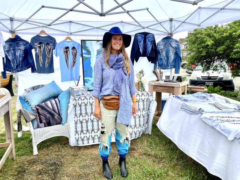 Boothbay native Morgan Mitchell shows off handpainted shirts and jackets at the 59th Windjammer Days’ Artists’ Alley. ISABELLE CURTIS//Boothbay Register