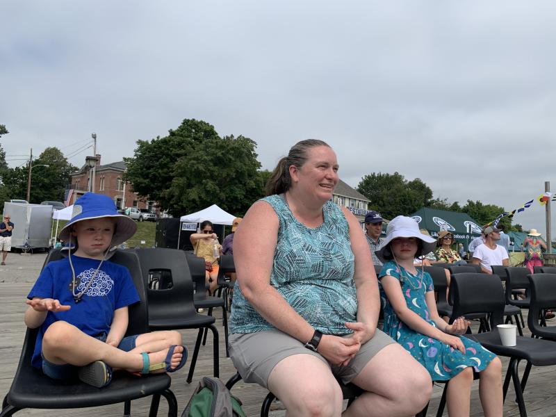 From left, Dresden’s Morgan Vining, 5, Sarah Vining and Quinn Vining, 6, take in the chanties at Schoonerfest Aug. 21. SUSAN JOHNS/Wiscasset Newspaper