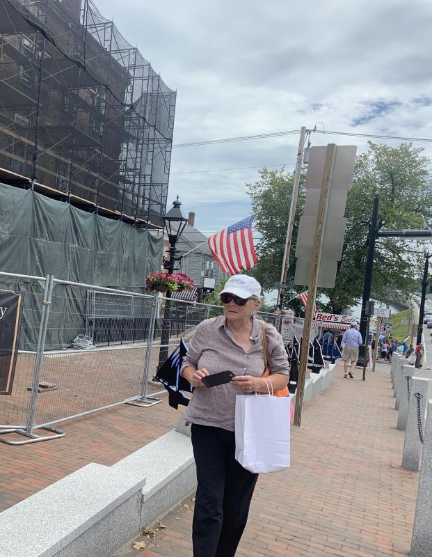 New York City’s Patricia Ladyko checks out the wooden silhouette schooner sculptures on Main Street, Wiscasset during Schoonerfest. SUSAN JOHNS/Wiscasset Newspaper