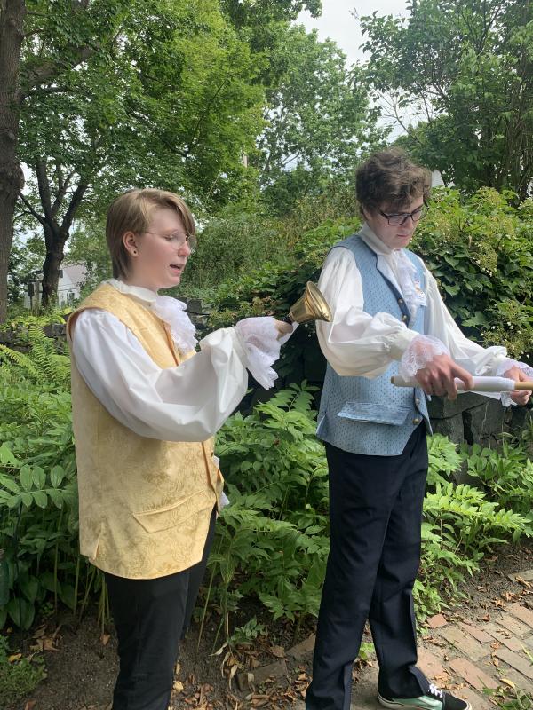 Wiscasset Middle High School seniors Leo Wren, left, and Evan Strong address Schoonerfest goers Aug. 18. SUSAN JOHNS/Wiscasset Newspaper