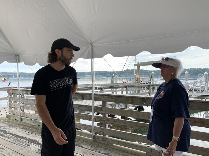 Water Street Kitchen & Bar General Manager Shane McCarthy talks with Schoonerfest’s Terry Heller about the beer and wine garden the restaurant was setting up for the festival. SUSAN JOHNS/Wiscasset Newspaper
