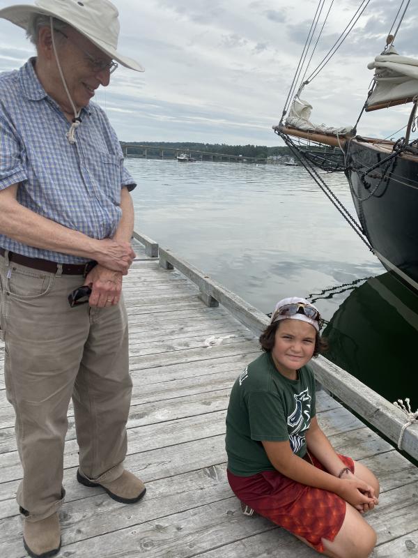 Wiscasset’s Marty Fox and grandson Asa Burchstead, 8, watch the schooners enter Wiscasset harbor Aug. 19. SUSAN JOHNS/Wiscasset Newspaper