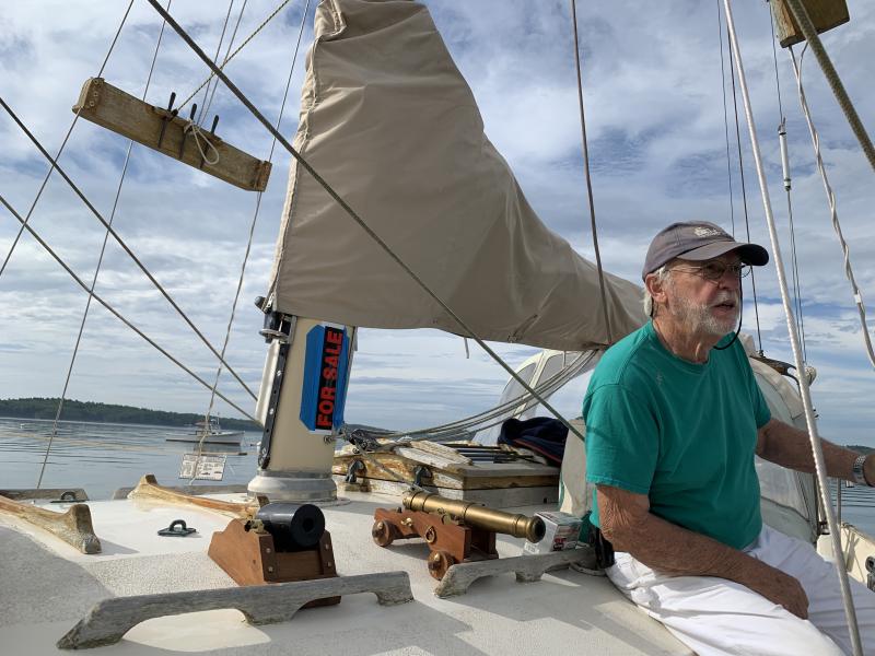Boothbay’s Alan Boyes, on his and wife Judy’s Pagan Moon, waits to head out to give When and If a cannon salute. SUSAN JOHNS/Wiscasset Newspaper