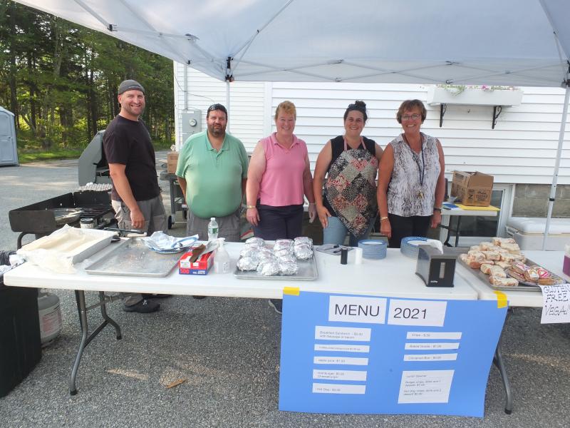 Southport Central School employees and volunteers sold a variety of baked goods and foods Aug. 21 during the annual firemen’s auction and yard sale. From left are Nick Ullo, Robbie Watts, Kim Burnham, Casey Martin and Lisa Clarke. BILL PEARSON/Boothbay Register