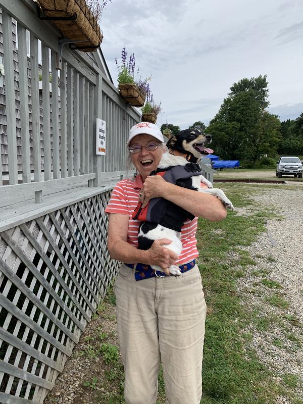 Mary Bowers of Alna with Toggle at Wiscasset Yacht Club, after their arrival Aug. 19 on the Sycamore, the schooner Bowers’ husband Fred built. SUSAN JOHNS/Wiscasset Newspaper
