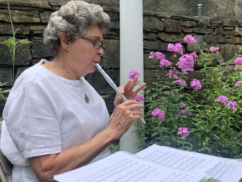Newcastle’s Nancy Parker plays a whistle in the Sunken Garden off Federal Street Aug. 18. SUSAN JOHNS/Wiscasset Newspaper