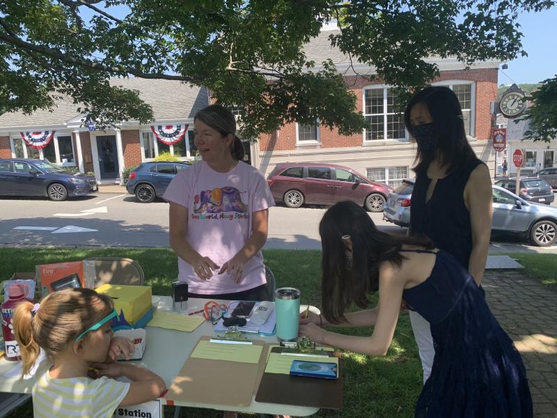 Jennifer Betts welcomes visitors. Weiwei Curtis and her daughter Maggie Curtis sign up. LILLY CURTIS/Boothbay Register