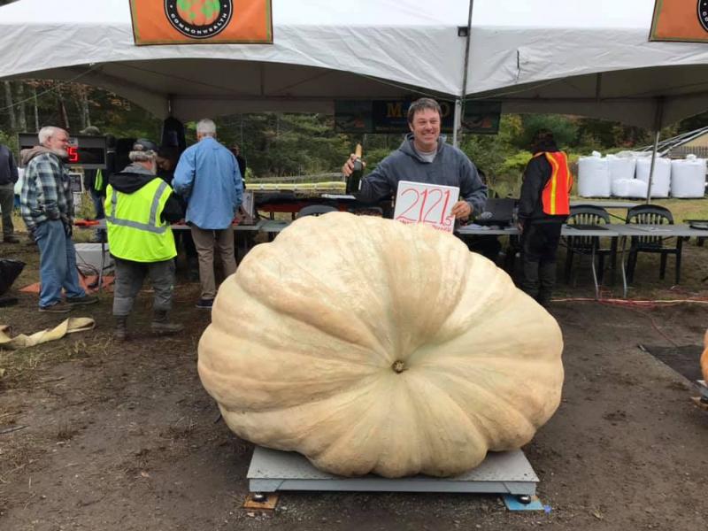 Champion Giant Pumpkin Grower Edwin Pierpont of Jefferson with his new state record winning Giant Pumpkin, which weighed in at 1212.5 pounds. It is also Maine’s first ton Giant Pumpkin. Charlie Lopresti photo