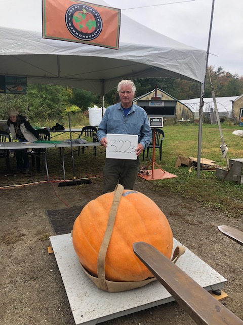 Guy Peaslee of Boothbay with his 322.5-pound pumpkin, good enough for third place in the volunteer Adult Pumpkin division. Kris Ward photo