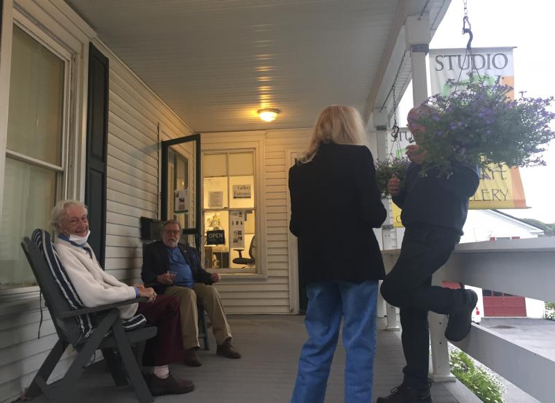 Artists Tony van Hasselt, left, and Terry Seaman (also the gallery owner) and guests sat outside for a spell. LISA KRISTOFF/Boothbay Register