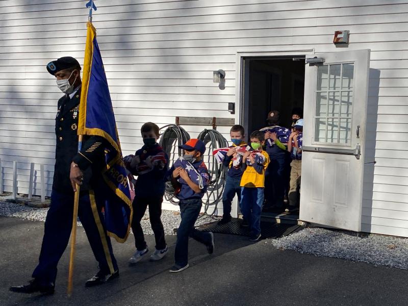 Americanism Officer Chris Armstead leads Boy Scout Troop 213 in a procession to dispose of retired American flags by burning. JOSEPH CHARPENTIER/Boothbay Register