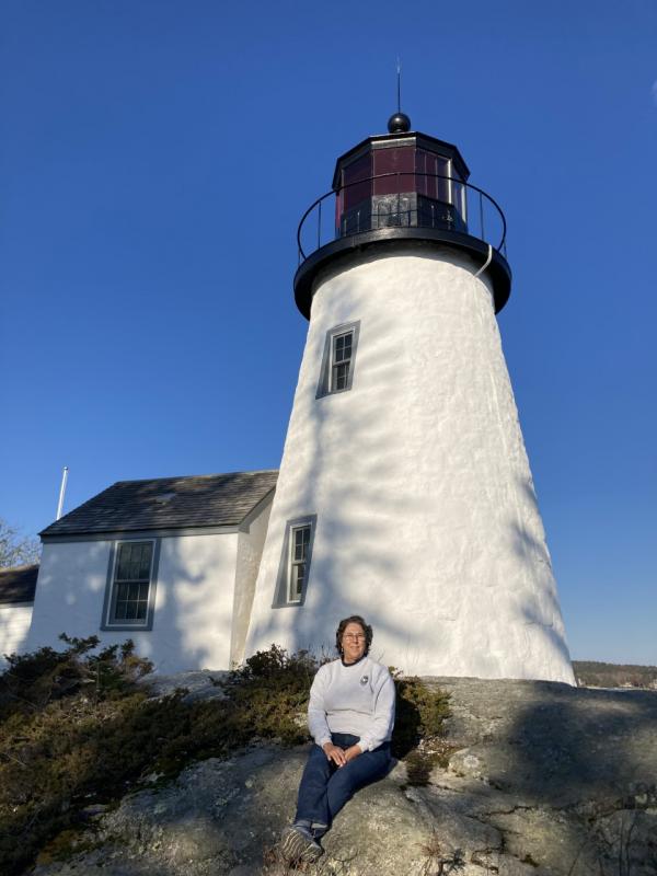 Keeper of the Light Elaine Jones sits in front of Burnt Island Lighthouse on its 200th anniversary Nov. 9. Jeremy Jones photo