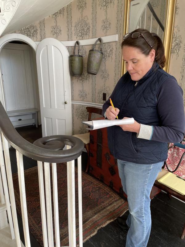 In the Nickels-Sortwell House front hall, floral designer Laura Tibbetts makes detailed notes for the seasonal displays she’ll create for tours during Wiscasset Holiday Marketfest. Marketfest photo