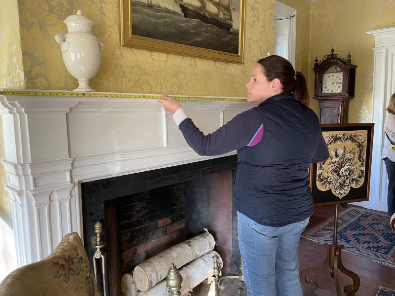 Floral designer Laura Tibbetts takes measurements of the Nickels-Sortwell House rooms in preparation for creating floral displays. Marketfest photo