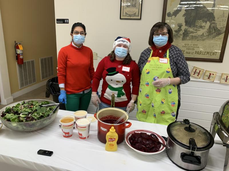 Betsy Smale, left, Jamie House and Pam Kamen, right, served up some Christmas cheer during the annual Community Dinner at the Boothbay American Legion Hall. BILL PEARSON/Boothbay Register