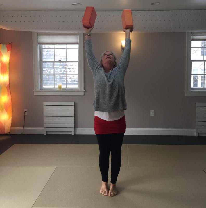 Sharon Goldhirsch, owner and teacher at Crow Point Yoga, going for the stretch. LISA KRISTOFF/Boothbay Register
