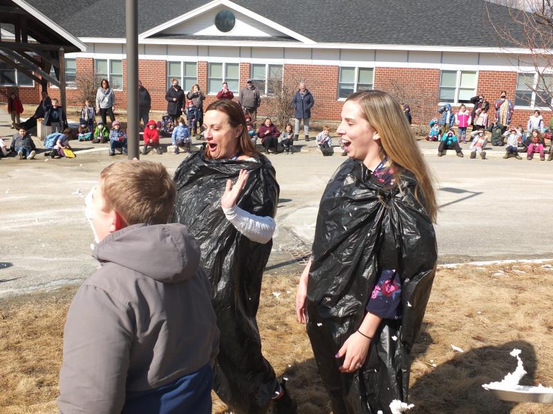 Jackson Zehm and Ethan Clark missed their target of putting a pie in the face of their teacher Nicole Ellis, right, and Principal Dr. Christina Boursaw on March 14. BILL PEARSON/Boothbay Register