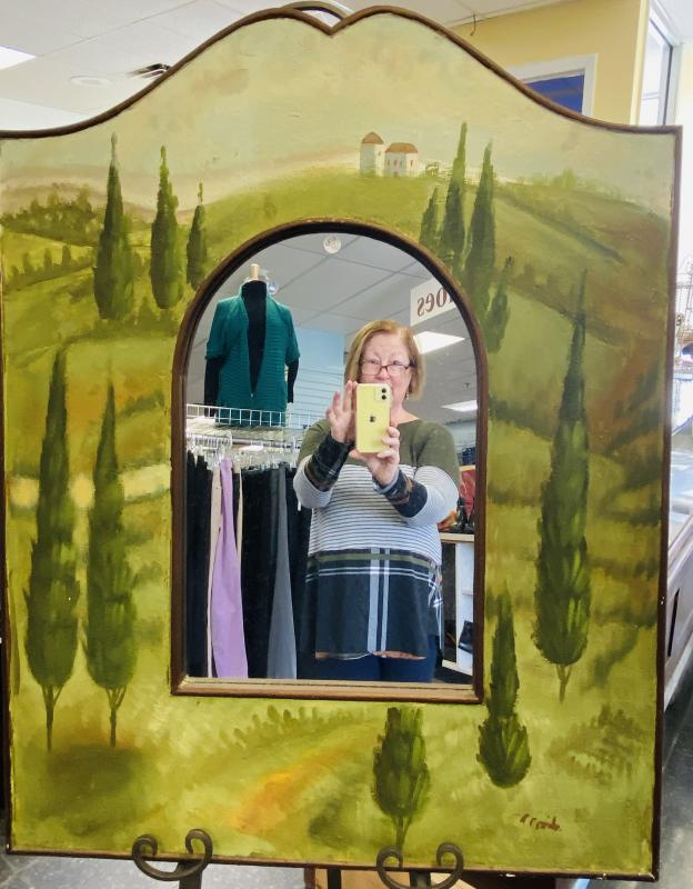 Auxiliary President Laura Zajdel taking shop photos for the St. Andrews Auxiliary Thrift Shop Facebook page. Courtesy of St. Andrews Auxiliary
