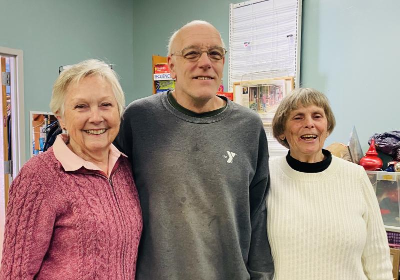 Back room heavy lifter Richard Teague pauses for a moment with volunteers Sue Hochstein, left, and Judy Boyes. Courtesy of St. Andrews Auxiliary