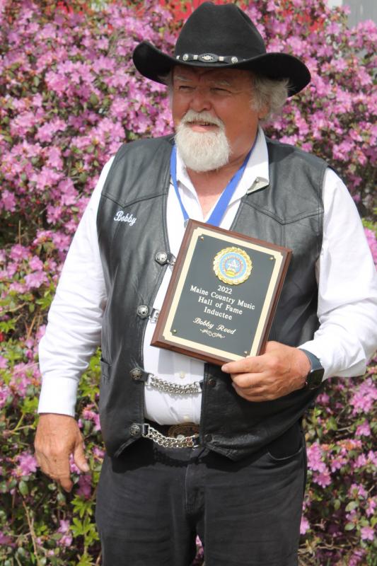 Bobby Reed holds the Maine Country Music Hall of Fame plaque he received May 15. Courtesy of Brittany Reed
