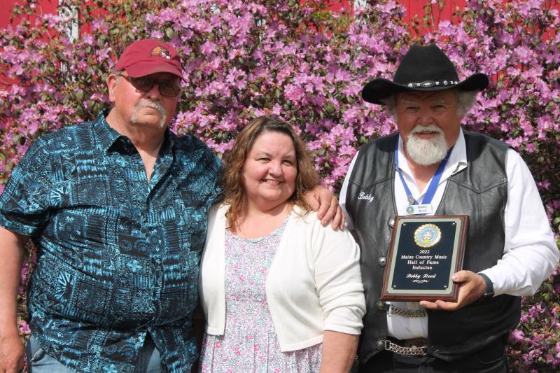 Reed’s brother David Reed and sister Shelly Clifford with the newest member of the Maine Country Music Hall of Fame. Courtesy of Brittany Reed