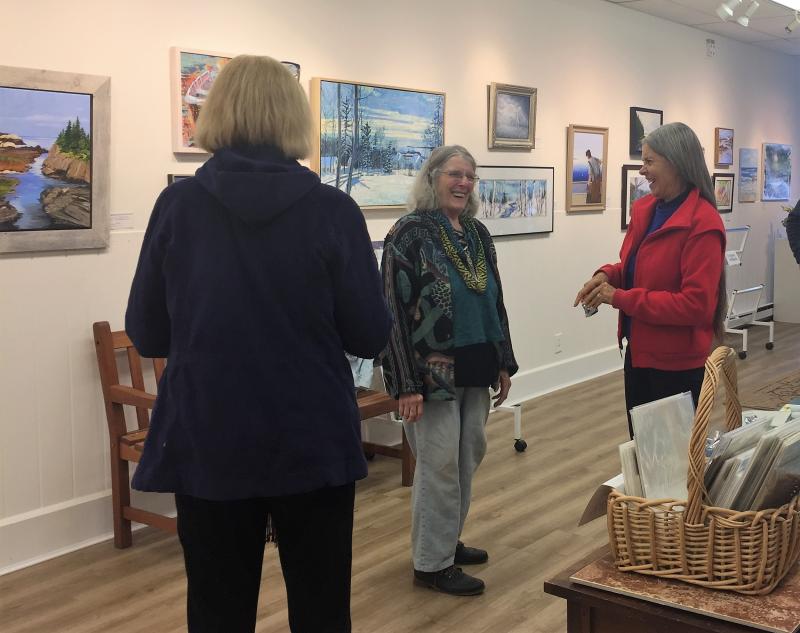 June Rose, center, shares a laugh with a few art lovers during the first First Friday in Boothbay Harbor on June 3 at Boothbay Region Art Foundation. LISA KRISTOFF/Boothbay Register