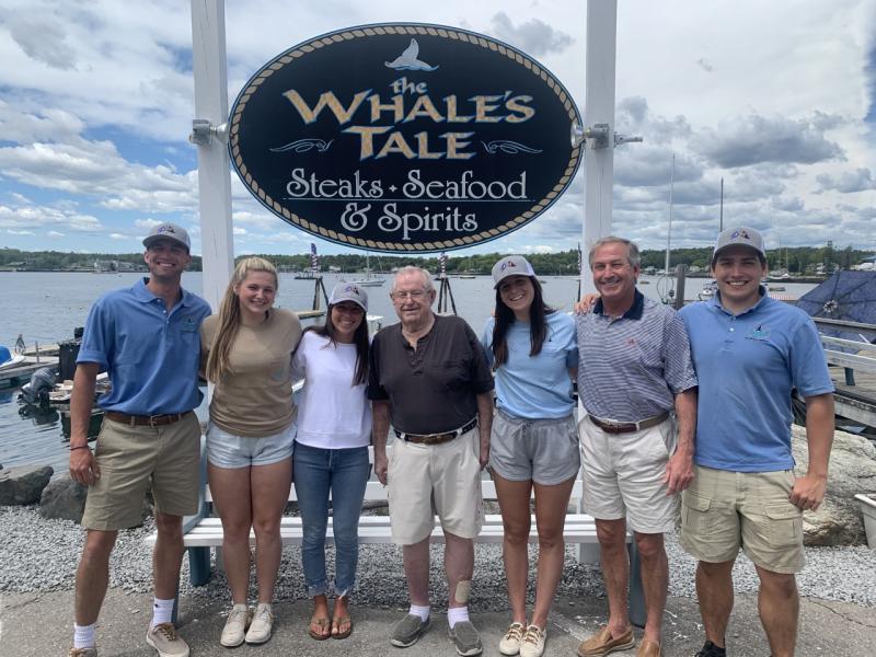 New ownership has brought some new faces to Carousel Marina and Whale’s Tale Pub. But one face remains familiar at least for this year. Former owner Jack Cogswell will work at the facility until October. Pictured, from left, Evan Hepburn, Veronica Russell, Jax van der Veen (owner), Cogswell, Emma Rose and Mike van der Veen (owners), and Graham Harris. BILL PEARSON/Boothbay Register
