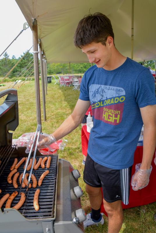Rising BRHS senior Gryffin Kristan tends the grill. Peter Southwick photo