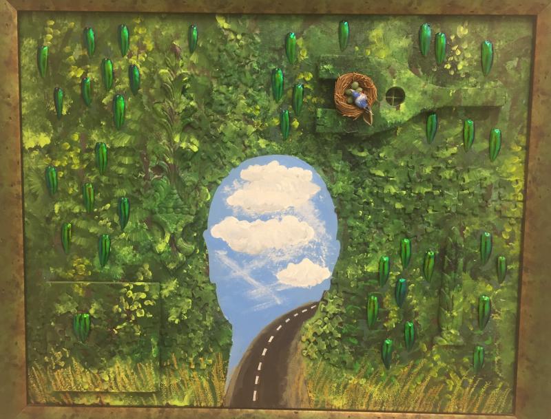 “Head in the Clouds” by Wendy Clayton. This mixed media includes puzzle pieces and Tibetan beetle wings. See it at BRAF.