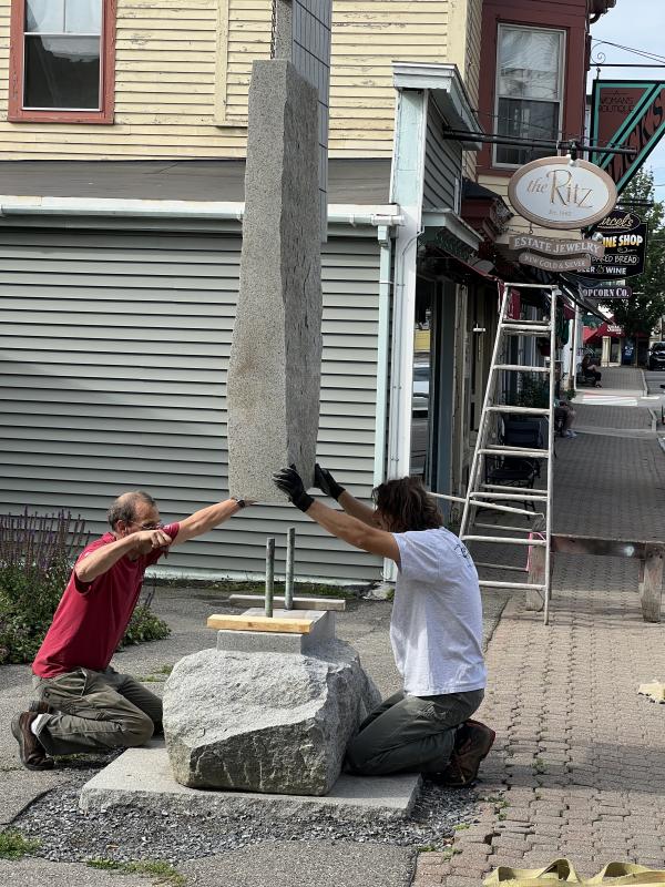 Mark Herrington, left, is assisted by Joseph DiMauro with installing his 14-foot “Lifting Fog” sculpture. Patricia Royall photo