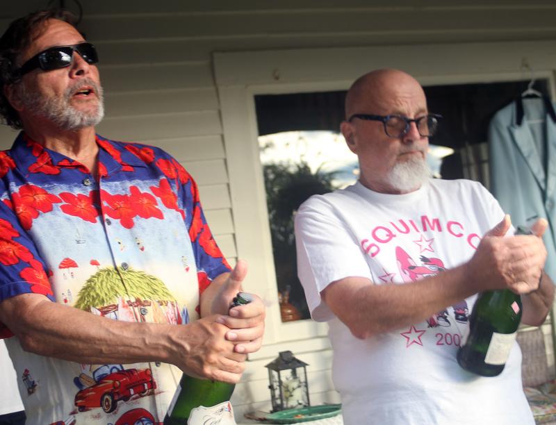 Guitarist John Wells, left, and band leader and bass player Ken Steiner pop the corks in celebration of Hennessy’s 100th. STEVE EDWARDS/Boothbay Register