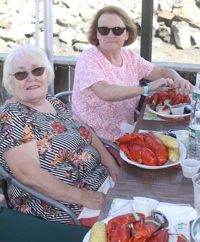 Two lobsters, corn and clams for Suzanne Raudenbush, left, and Emma Benner, STEVE EDWARDS/Boothbay Register