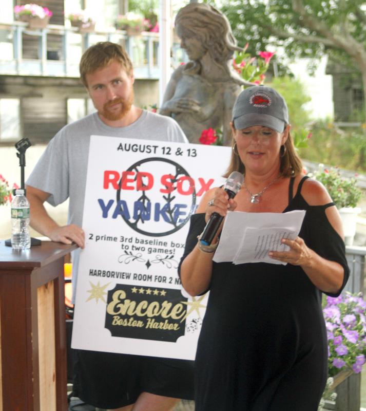 Troy Plummer and Sharon Rose of WCSH-TV auction off one of the top items in the live auction at the MLA fundraiser at Brady’s on Aug. 7. STEVE EDWARDS/Boothbay Register
