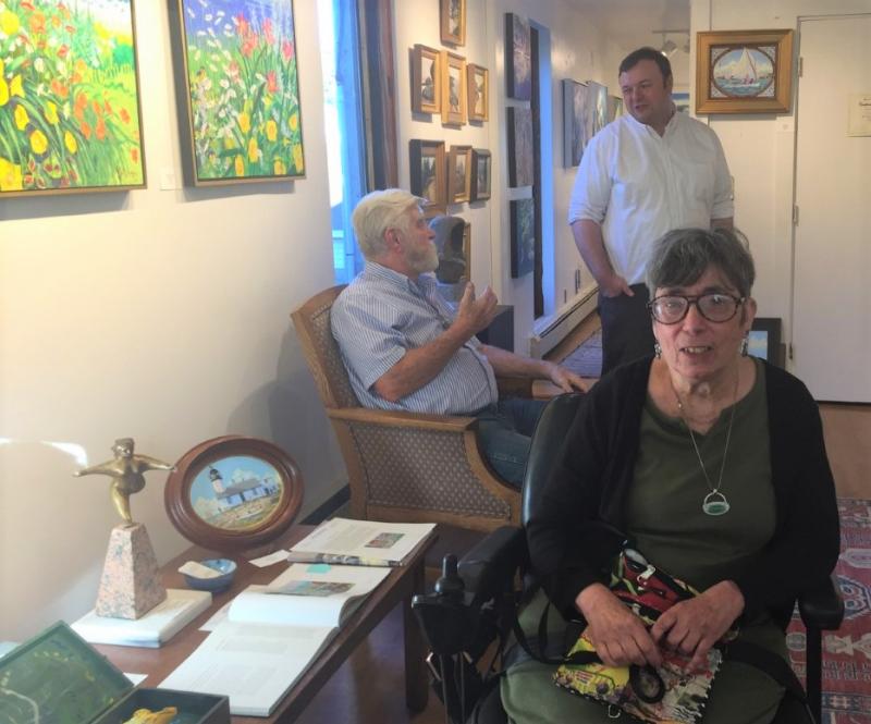 Artist Andrea Peters, forefront, at the opening reception for her new show at Gleason. Behind her on the left are her husband, Mark Peters, and Andrew Gleason. LISA KRISTOFF/Boothbay Register
