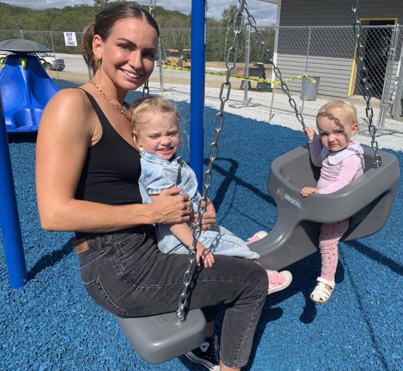 Lindsay Lee enjoys a ride along with her daughters Lucia, 1, and Kiana, 3, on Sept. 14 at the new Clifford Park Playground. BILL PEARSON/Boothbay Register