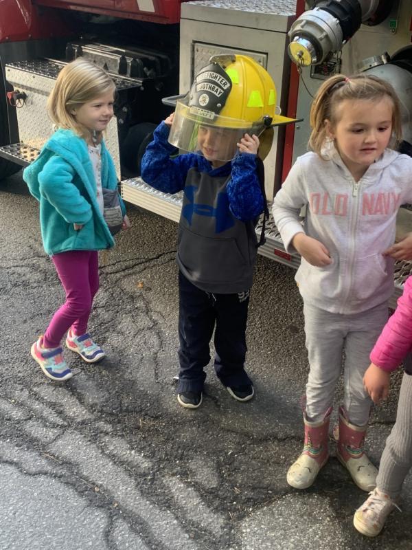 Pre-kindergartener Angus Kaler looks like a future firefighter during a Boothbay-Boothbay Harbor fire department visit to BRES on Oct. 11. BILL PEARSON/Boothbay Register